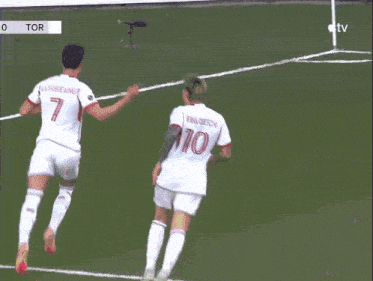 two soccer players on a field with one wearing number 10
