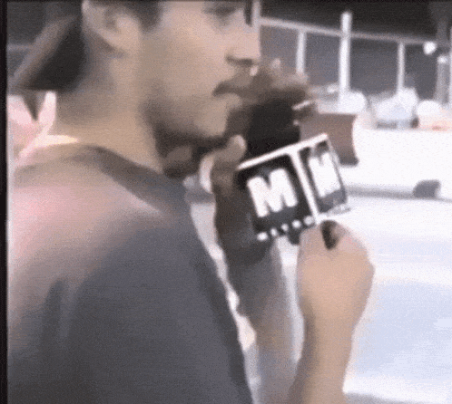 a man holding a microphone that says mm on it