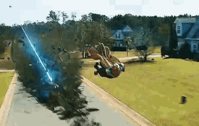a person is flying through the air with a lightning bolt coming out of their mouth .