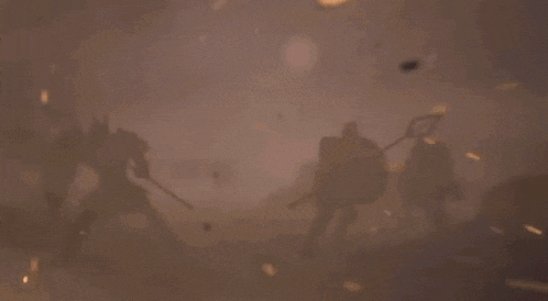a group of people are fighting in a dark room