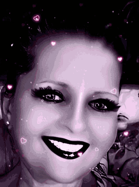 a black and white photo of a woman with pink hearts around her