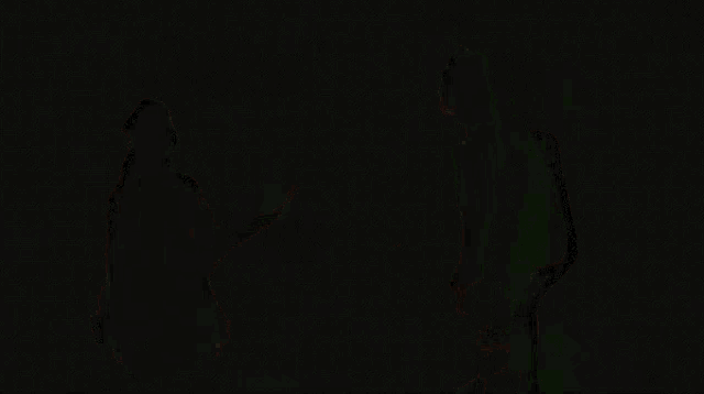 a blurred image of a person holding hands in front of a flame