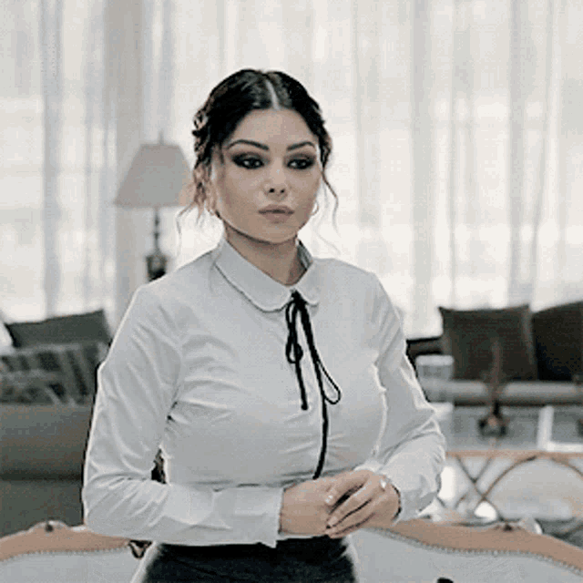a woman in a white shirt with a black tie