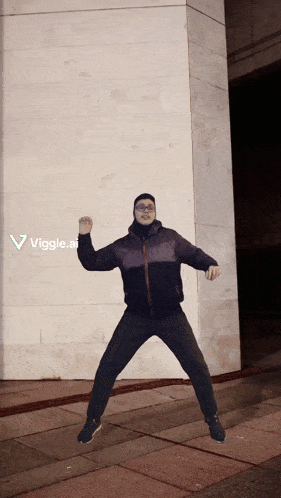 a man is jumping in front of a wall with a viggle.ai logo on the bottom right
