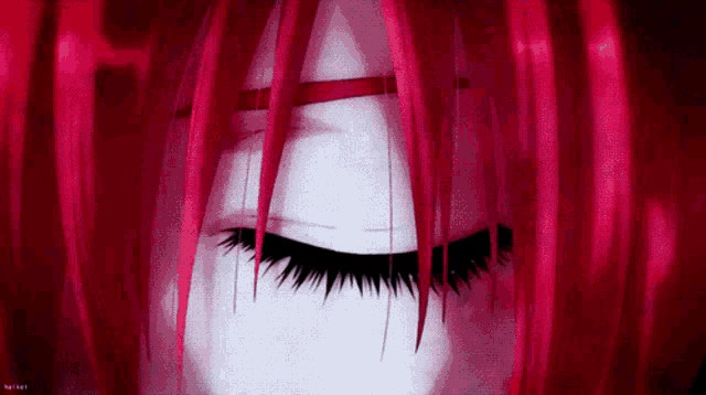 a close up of a person 's eye with red hair .