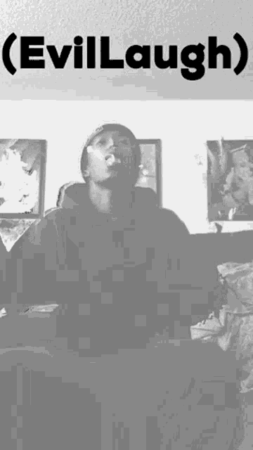 a black and white photo of a man smoking a cigarette with the words ( evillaugh ) below him