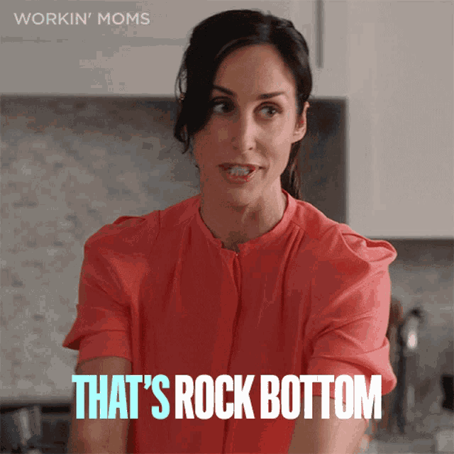 a woman says that 's rock bottom in front of a kitchen