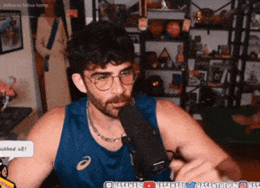 a man talking into a microphone with the words indica vs sativa horny in the background