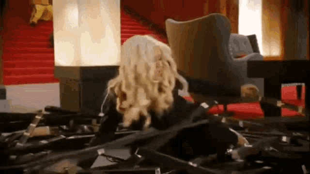 a woman is laying on a table with a lot of records on it .