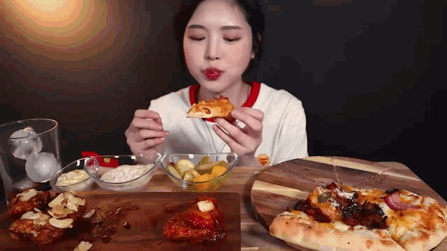 a woman is eating a slice of pizza with a fork