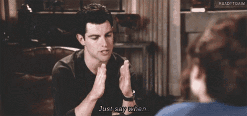 a man is sitting on a couch talking to a woman and says just say when .