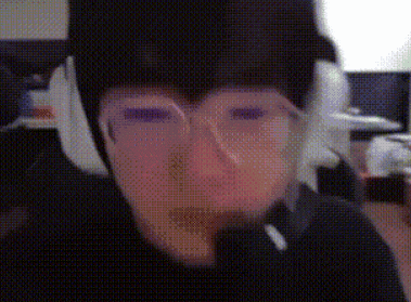 a person wearing glasses and headphones looks at the camera .