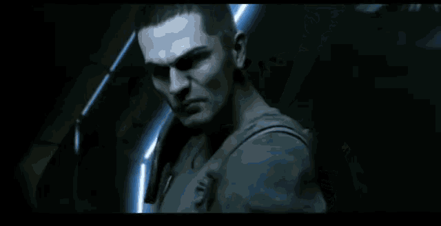 a man wearing a headset stands in the dark