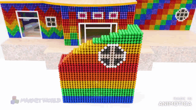 a house made out of magnets with the words magnetworld on the bottom