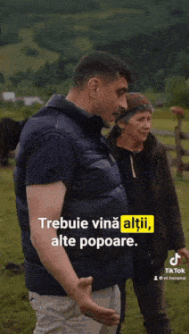 a man and a woman standing in a field with a caption that says trebuie vina altii alte popoare