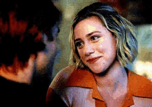 a man and a woman are looking at each other .