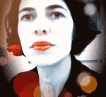 a close up of a woman 's face with a flower in her ear .