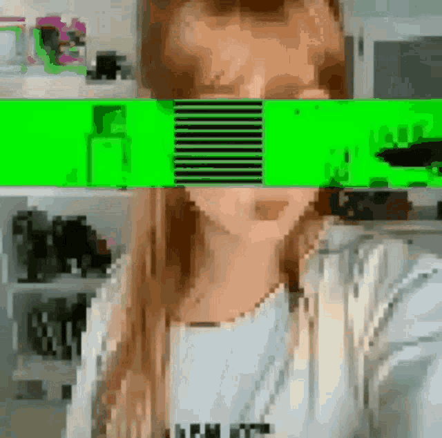 a woman 's face is obscured by a green stripe