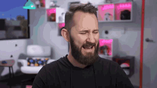 a man with a beard is making a funny face with his mouth open