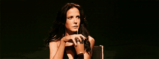 a woman drinking a cup of coffee with a straw