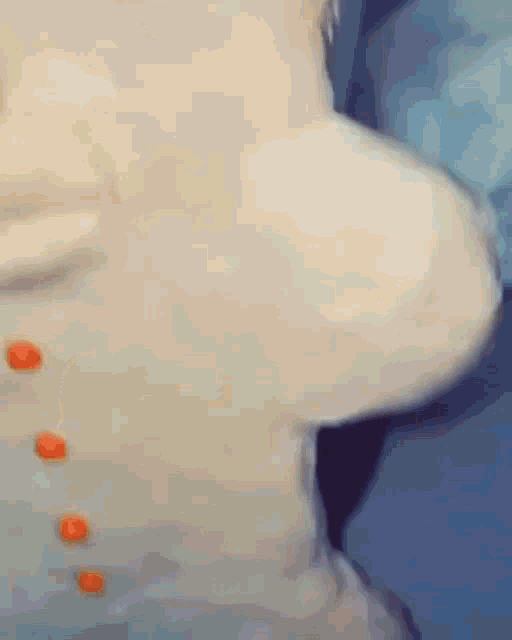 a close up of a person 's face with red buttons on it