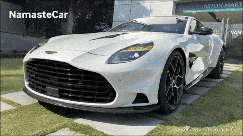 a white car is parked in front of an aston mart building