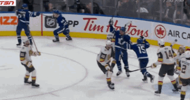 a hockey game is being played in front of a tim hortons ad