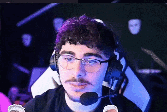 a man with glasses and a beard is wearing a microphone