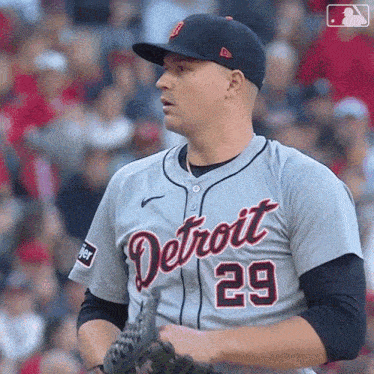 a baseball player for the detroit tigers holds his glove