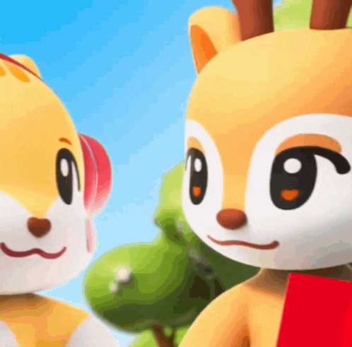 two stuffed animals are standing next to each other and one has a red scarf around his neck