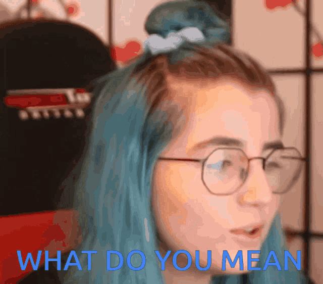 a girl with blue hair and glasses says what do you mean in blue letters