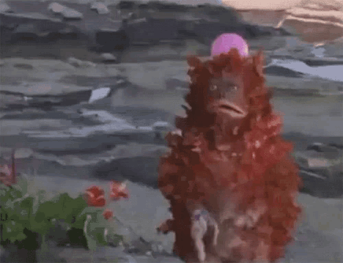 a painting of a strange creature with a pink flower in its mouth