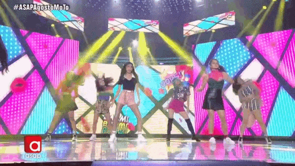 a group of women are dancing on a stage with asap written on the bottom right