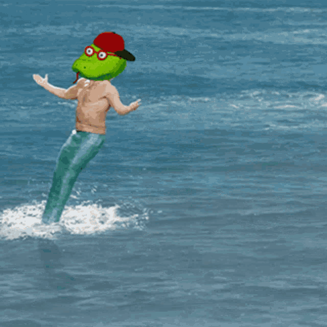 a man with a frog head and a red hat is in the ocean