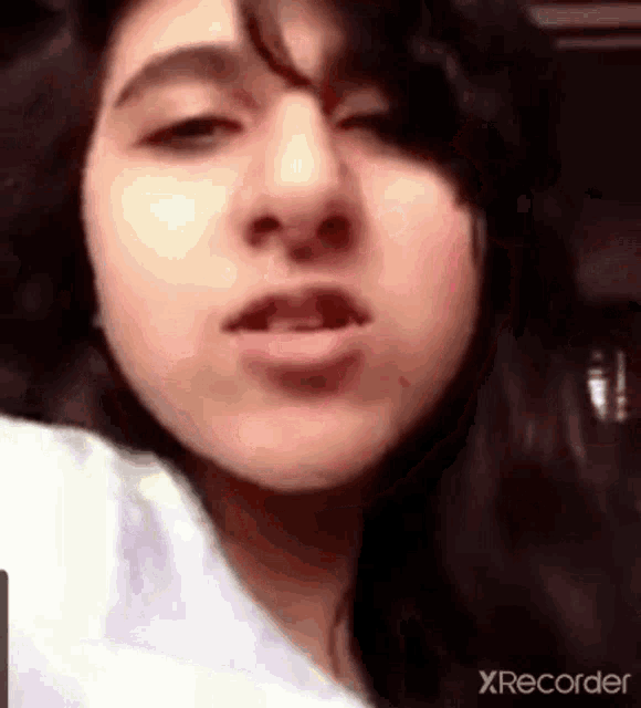 a close up of a woman 's face with a xrecorder watermark on the bottom right corner .