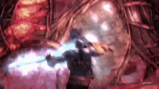 a man is holding a sword in a video game while standing in front of a large glowing object .