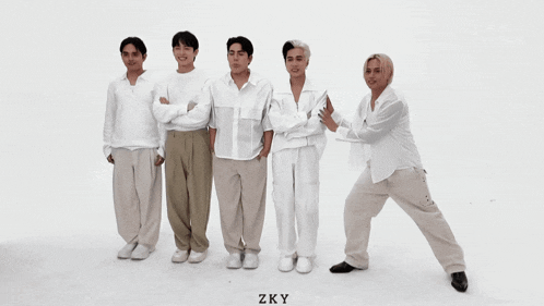 a group of young men are standing in a row with the word zky on the bottom