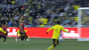 a soccer player with the number 9 on his jersey kicks the ball