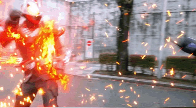 a person with a helmet on is surrounded by fire and sparks