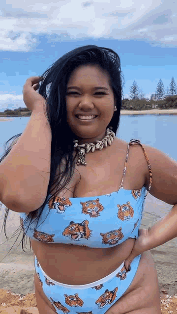 a woman in a bikini with tigers on it