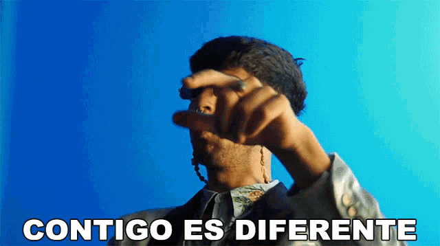 a man with a ring on his finger says " contigo es diferente " in spanish