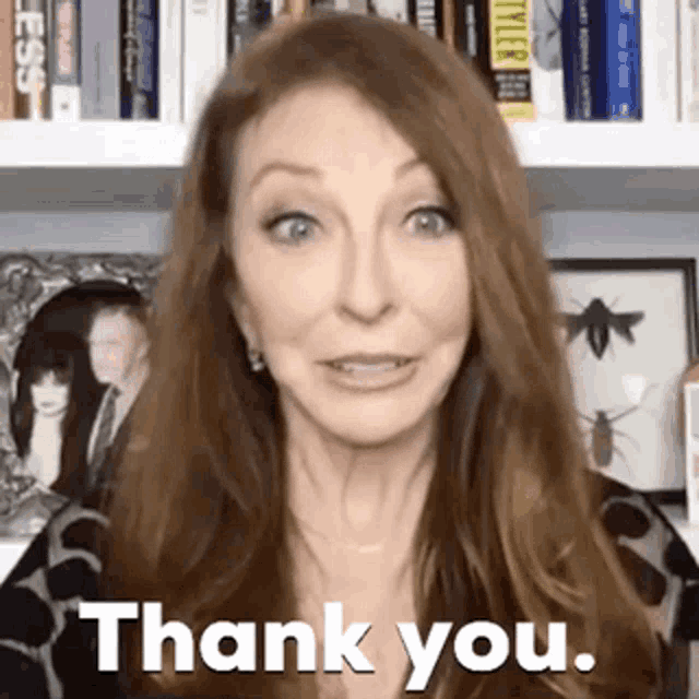 a woman is making a funny face and saying `` thank you '' .