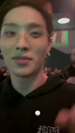 a pixelated image of a man 's face with a button that says ' snoopy ' on it