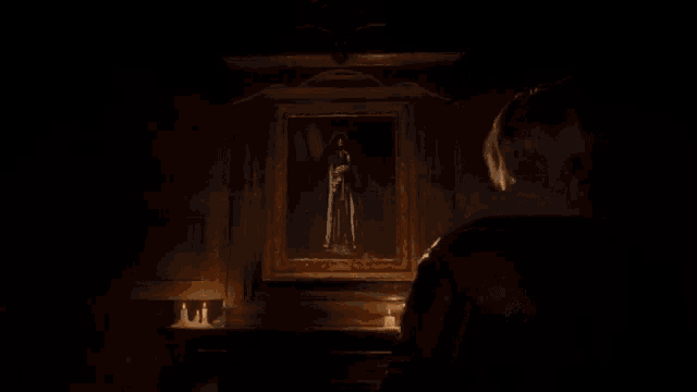 a woman stands in front of a painting of a ghost
