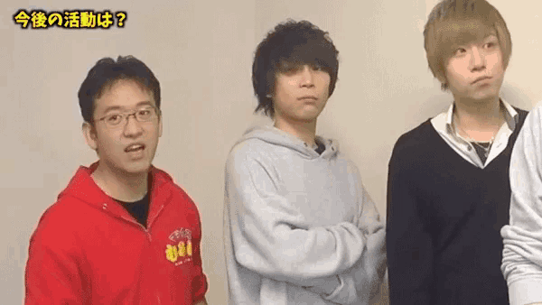 a group of young men are standing next to each other with their arms crossed in front of a wall .