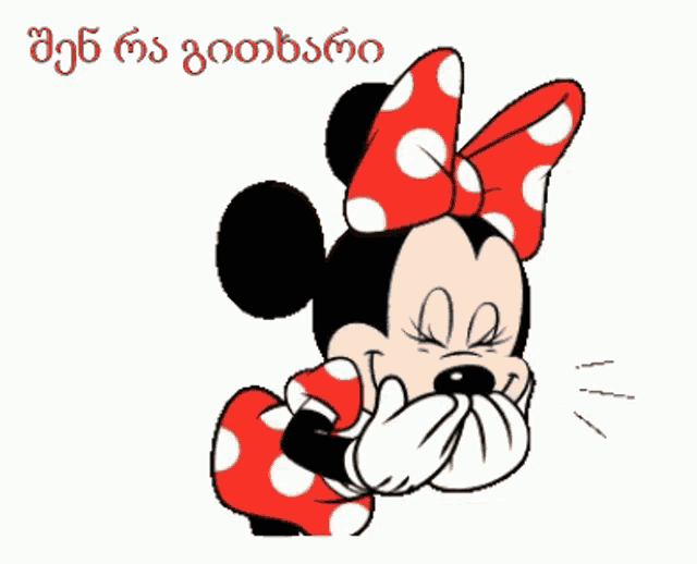 a cartoon of minnie mouse wearing a red dress with white polka dots and a bow