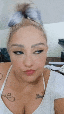 a woman has a tattoo on her chest that says ' i love you '