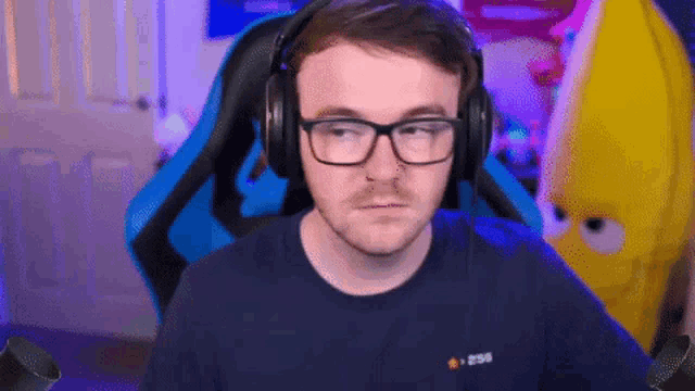 a man wearing glasses and headphones is looking at the camera