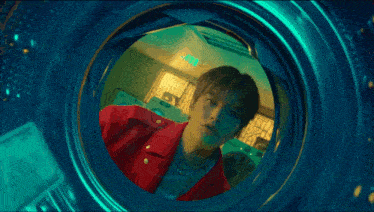 a person is laying in a washing machine with a bunch of money coming out of it