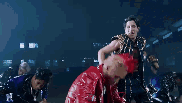 a man in a red jacket is surrounded by other people
